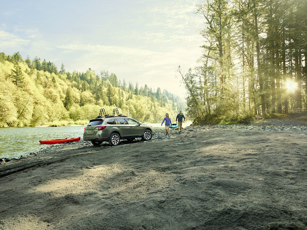 Retouched Subaru crosstrek silver SUV on beach with canoe mount