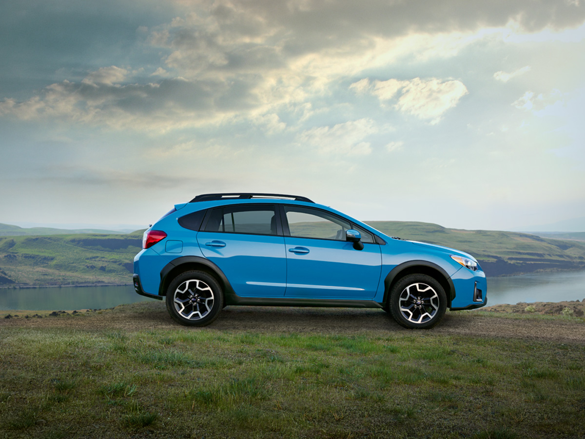 Retouched 2016 Subaru Crosstrek blue in hilly grasslands