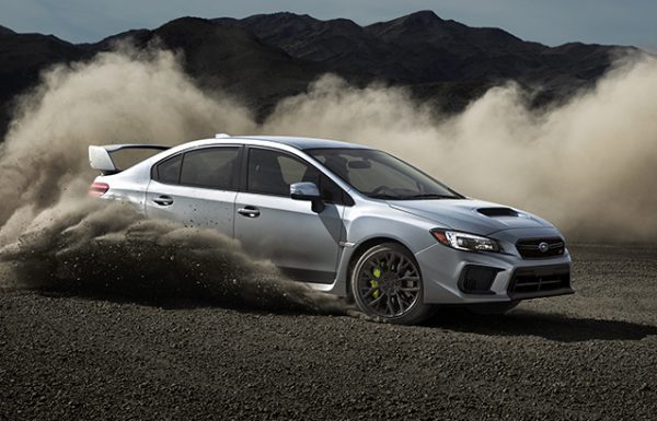 Retouched Subaru car skidding across gravel in desert