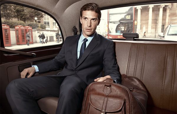 Retouched Man in Bombay High suit riding in the back of a car